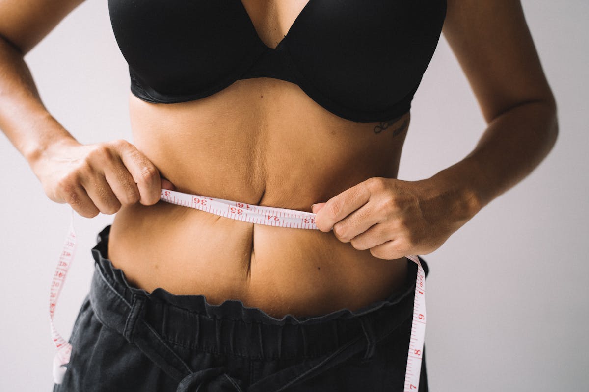 Hands measuring waistline — weight loss