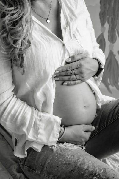 Pregnant woman holding belly