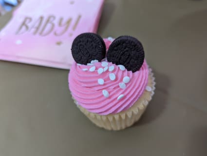 Minnie Mouse themed baby shower cupcakes with pink frosting and mini Oreos as ears