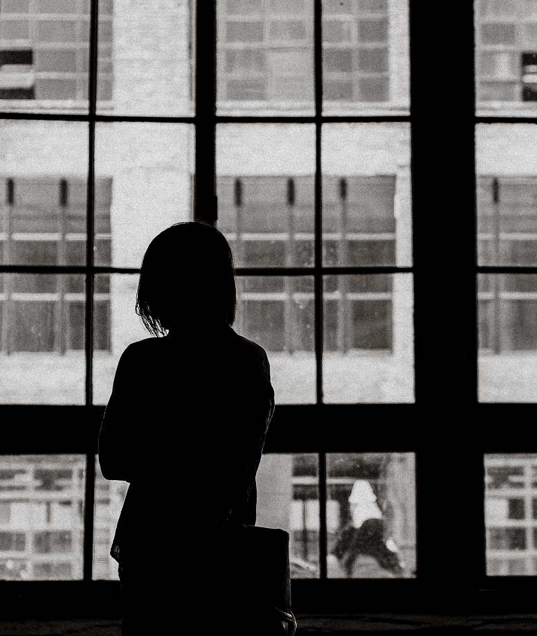 Person silhouette by window