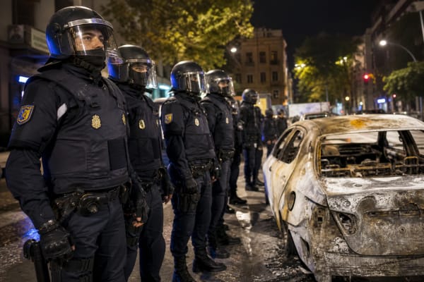 Spain sends thousands of extra riot police to cities as looting and arson spread into the weekend