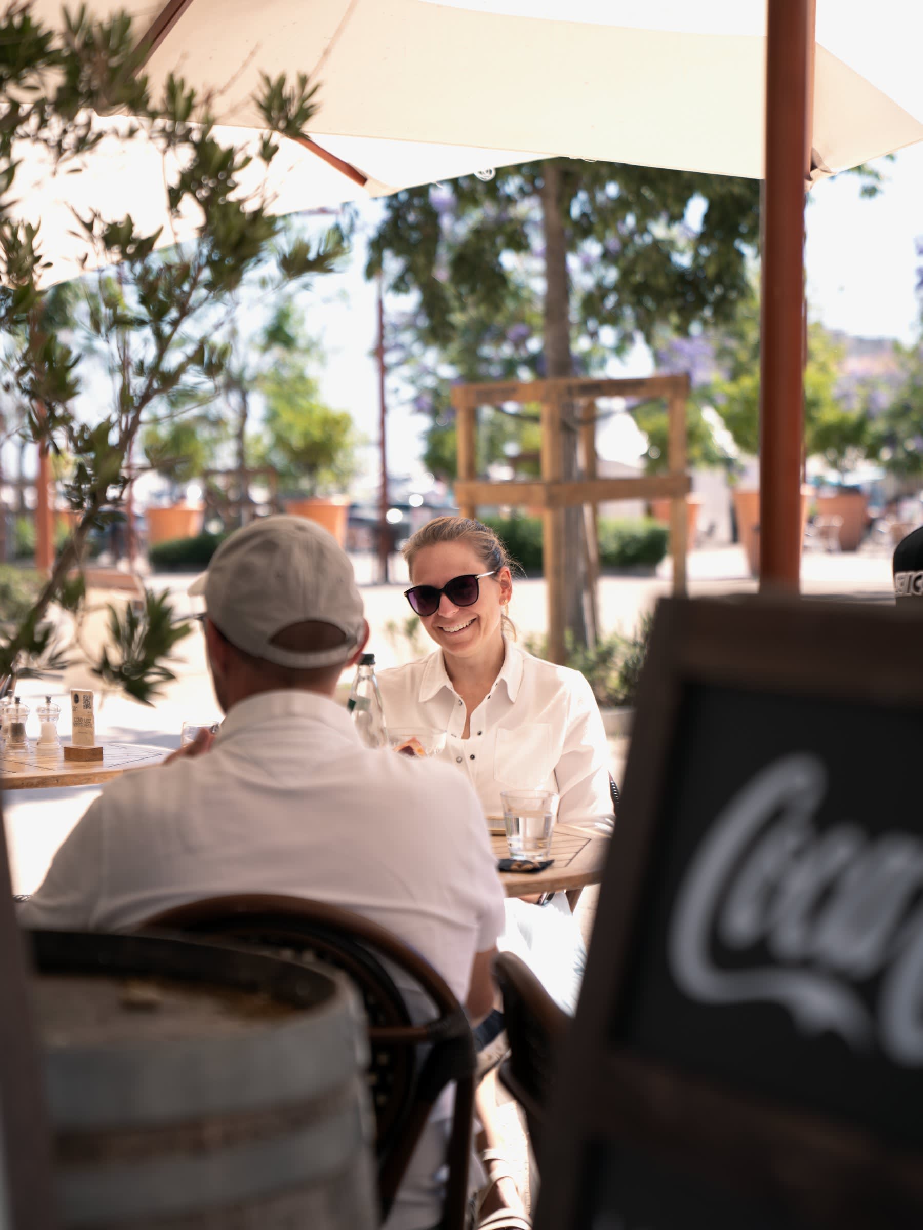 Une cliente souriante en terrasse