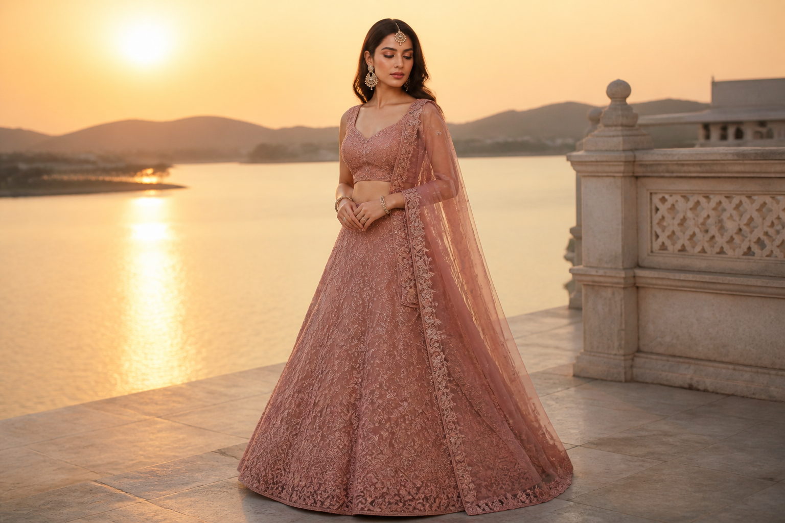 Fashion editorial photo of a model in a dusty rose net lehenga with tone-on-tone resham embroidery and glass beads, fabric draped softly in golden hour light.