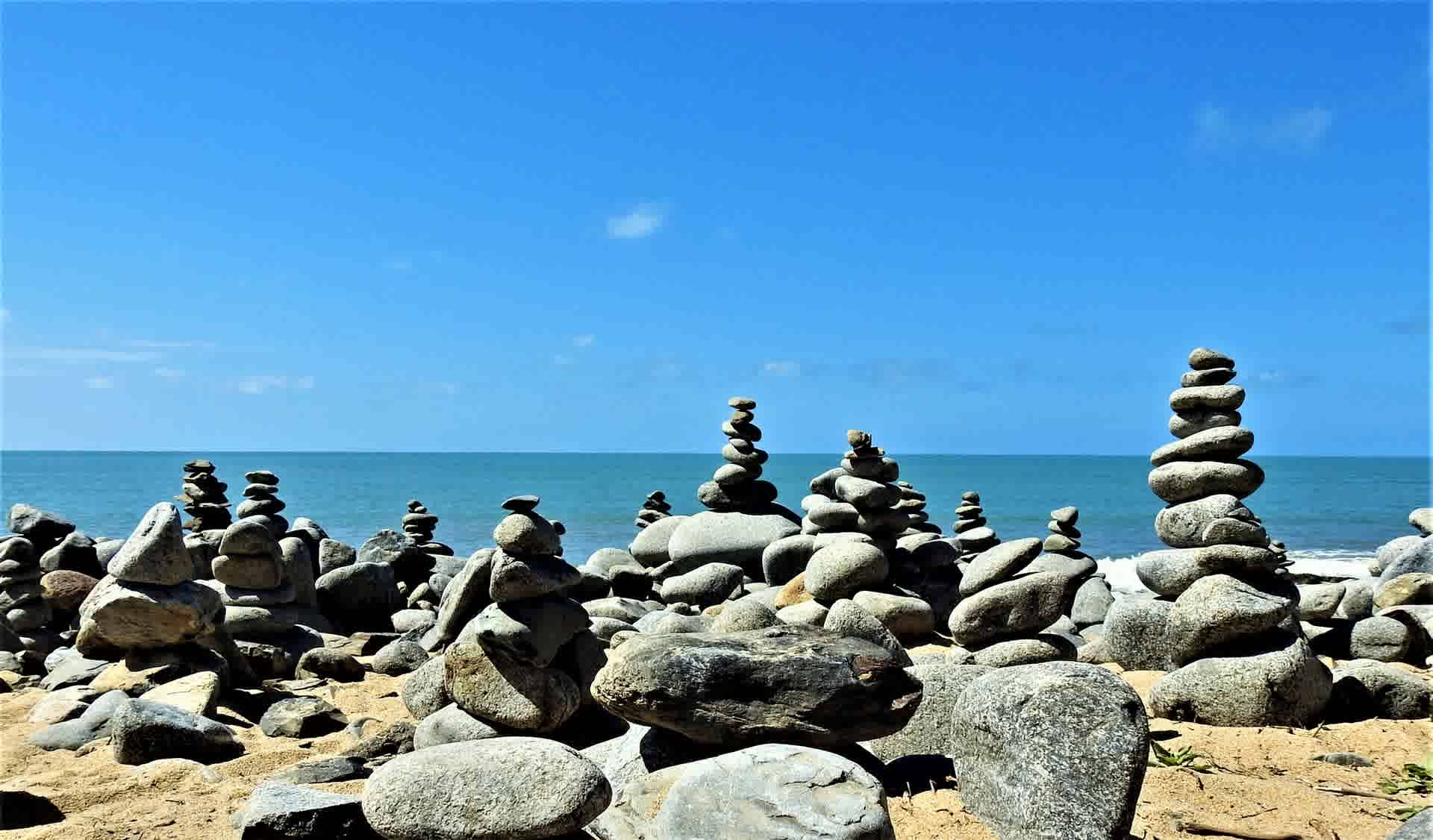 stones placed on top of each other in beach area