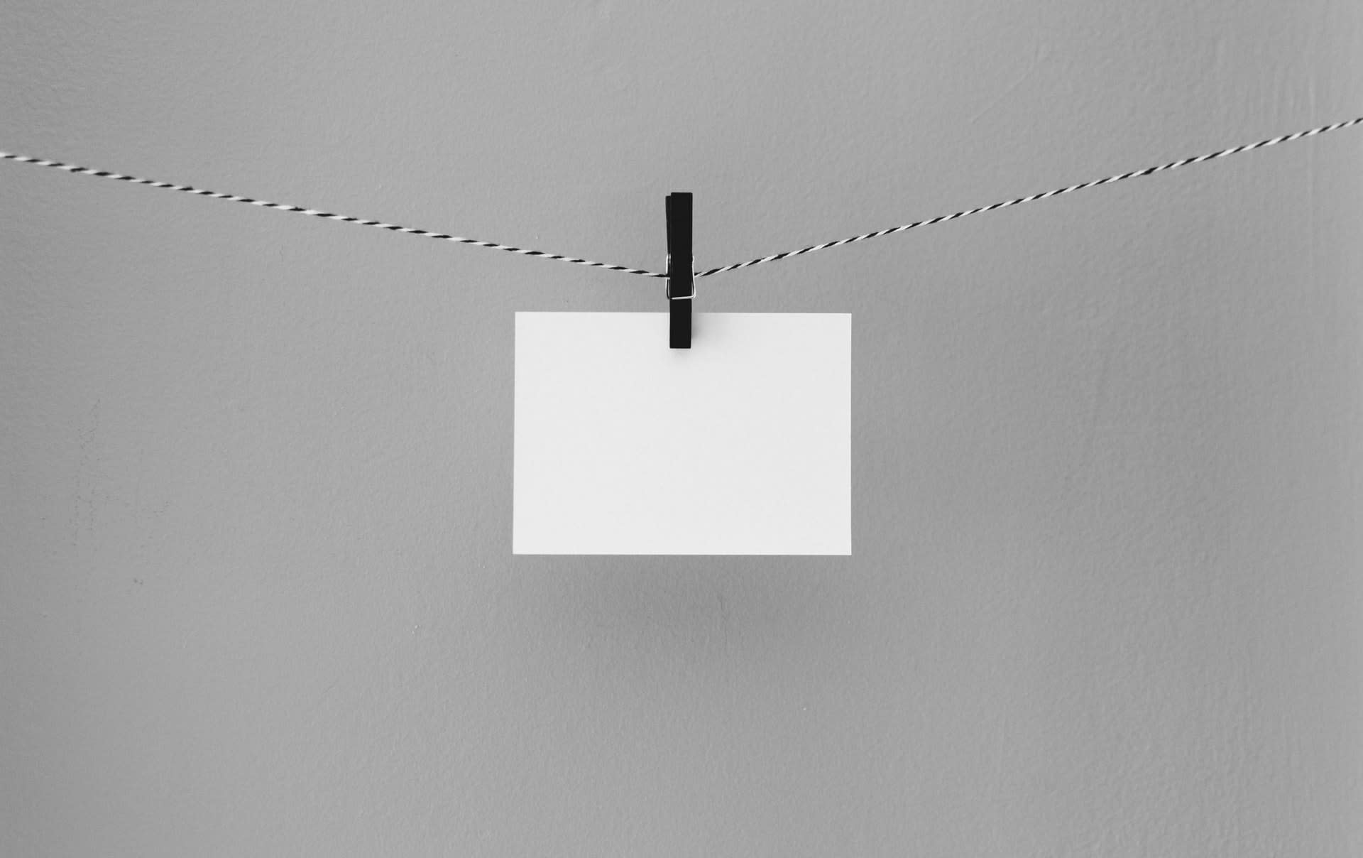 a piece of paper hanging on a string