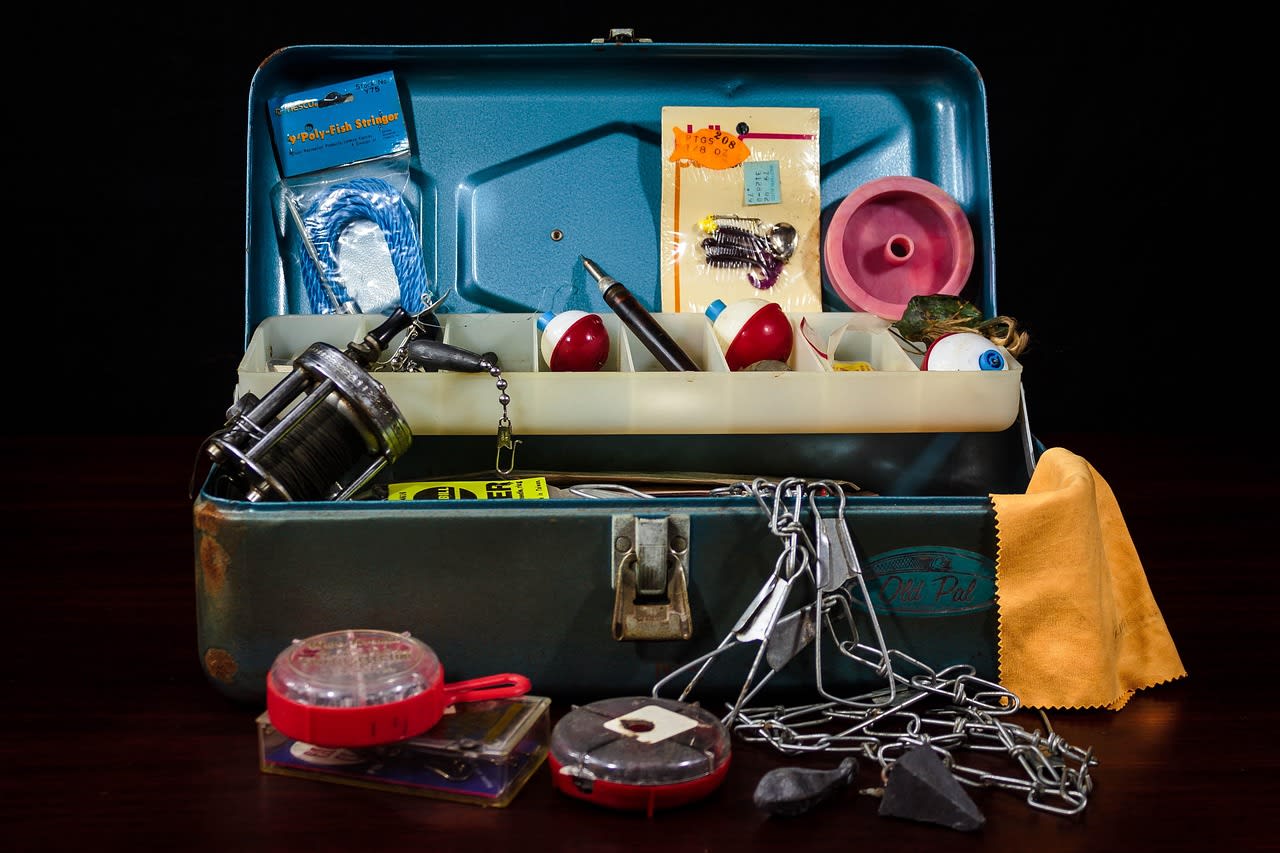 Open vintage tackle box with fishing gear