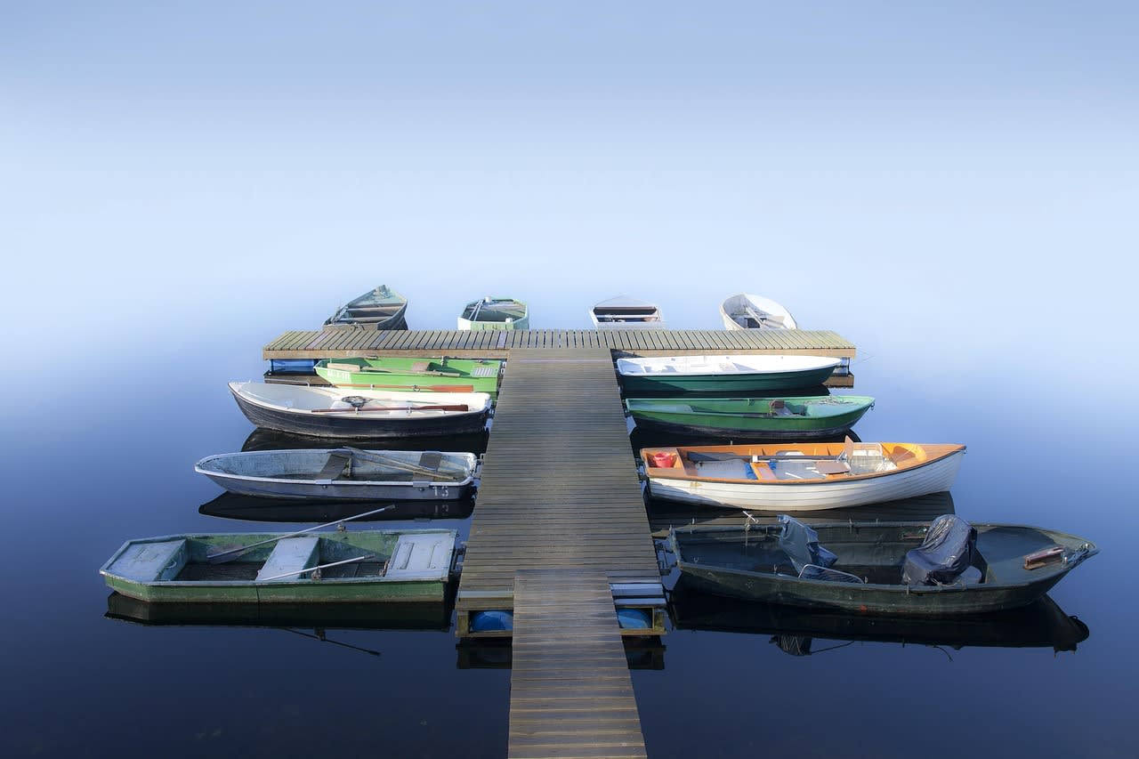 Small rental fishing boats tied up along a dock