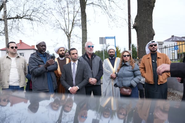 Delegation members pausing in reflection at the memorial