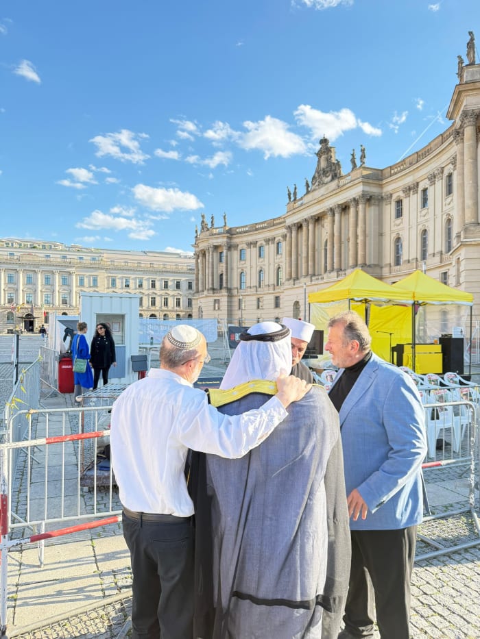 Sharaka delegates embracing at an interfaith gathering in Berlin