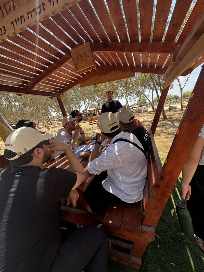 Sharaka volunteers in hard hats working on a wooden structure
