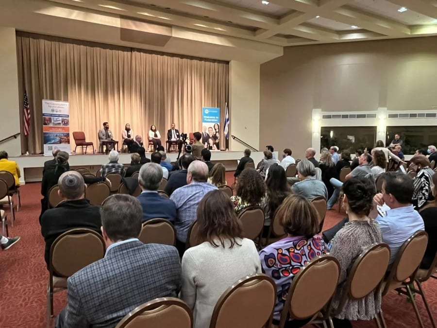 Sharaka speakers on stage at a community event in the United States