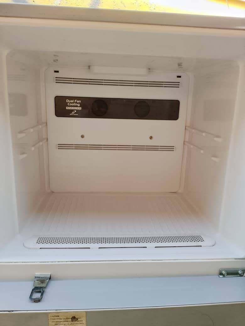 Freezer interior of used Hitachi top-mount refrigerator showing dual fan cooling system and clean condition