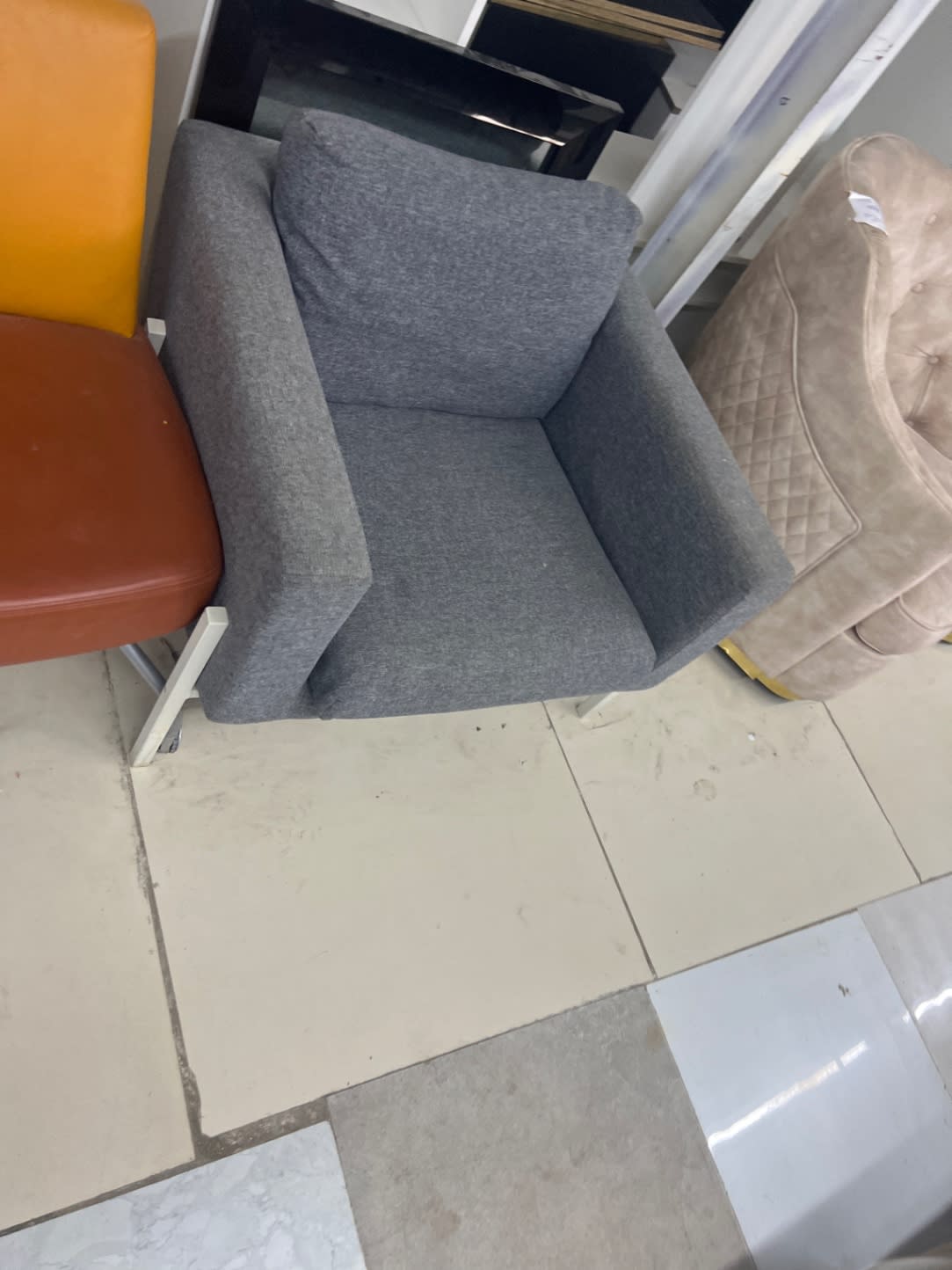 Side angle of used grey fabric single seat armchair at Bufaisal Shop D Ajman