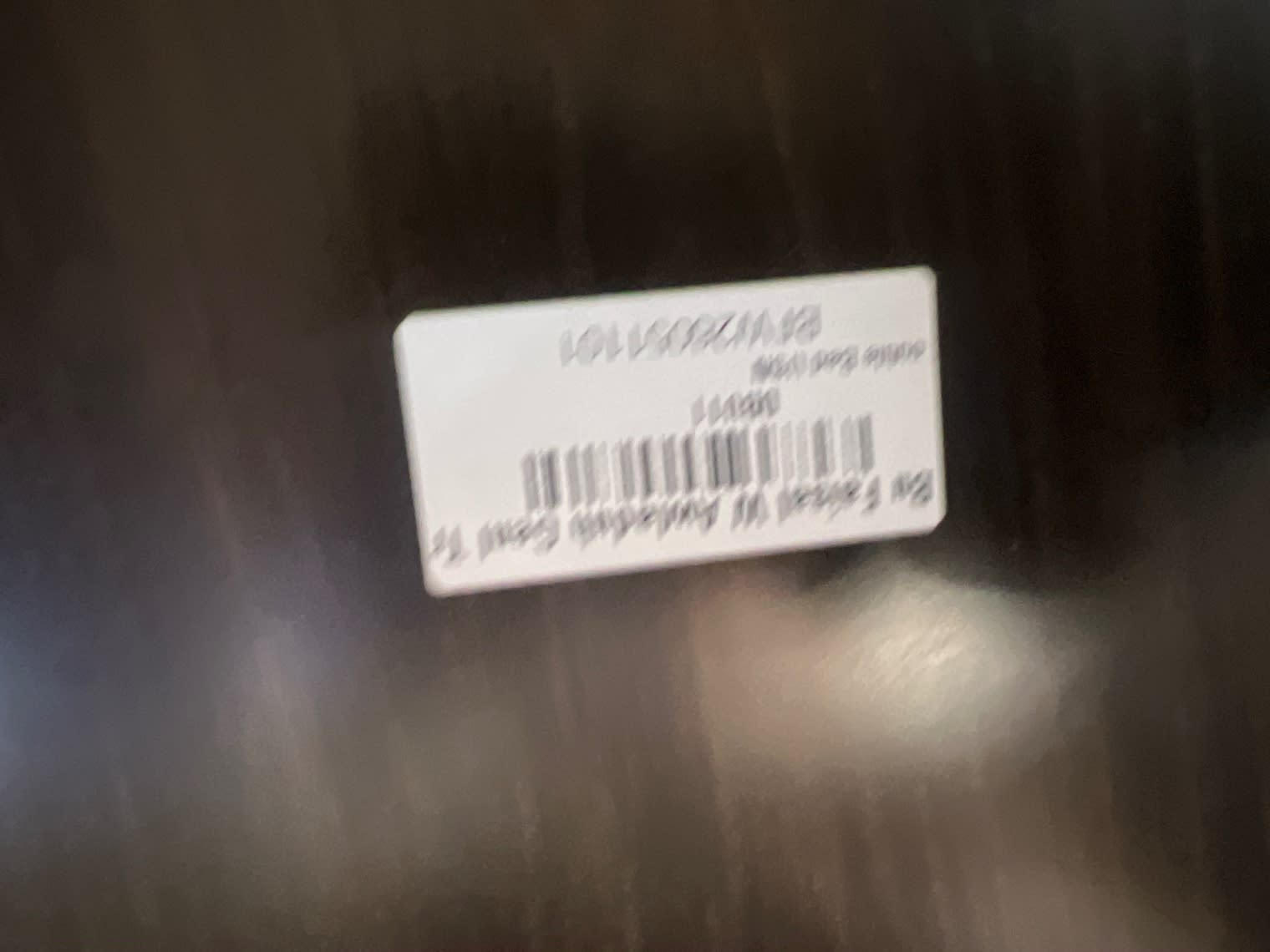 Bufaisal barcode label on used upholstered bed frame — label partially unreadable