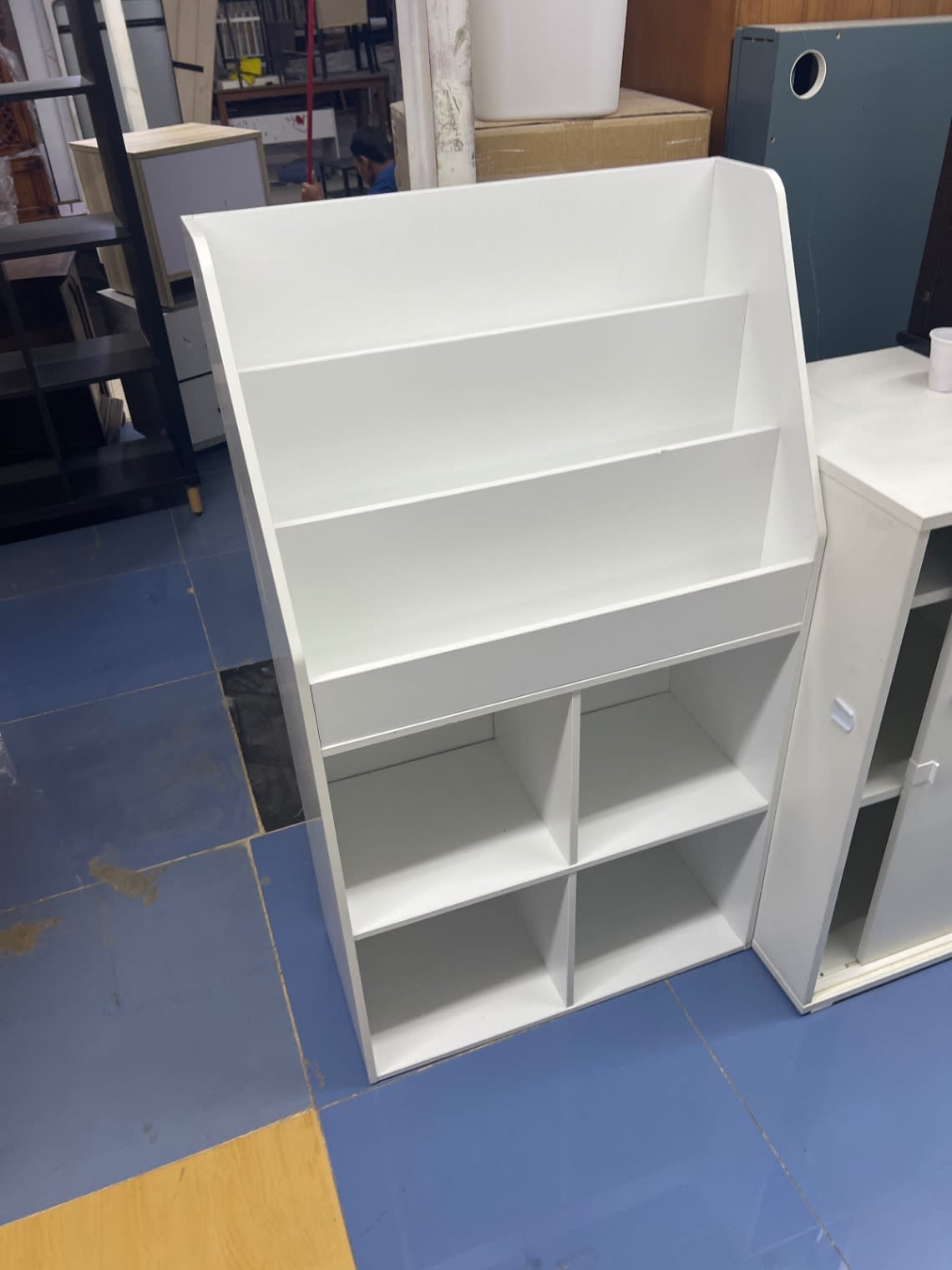 Used white kids bookshelf with storage cubbies, front view showing base scuffs, Bufaisal Shop D