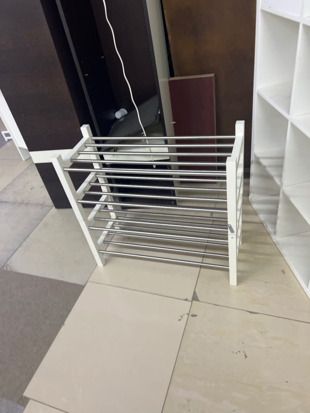 Side angle view of used 4-tier shoe rack white and chrome at Bufaisal Ajman