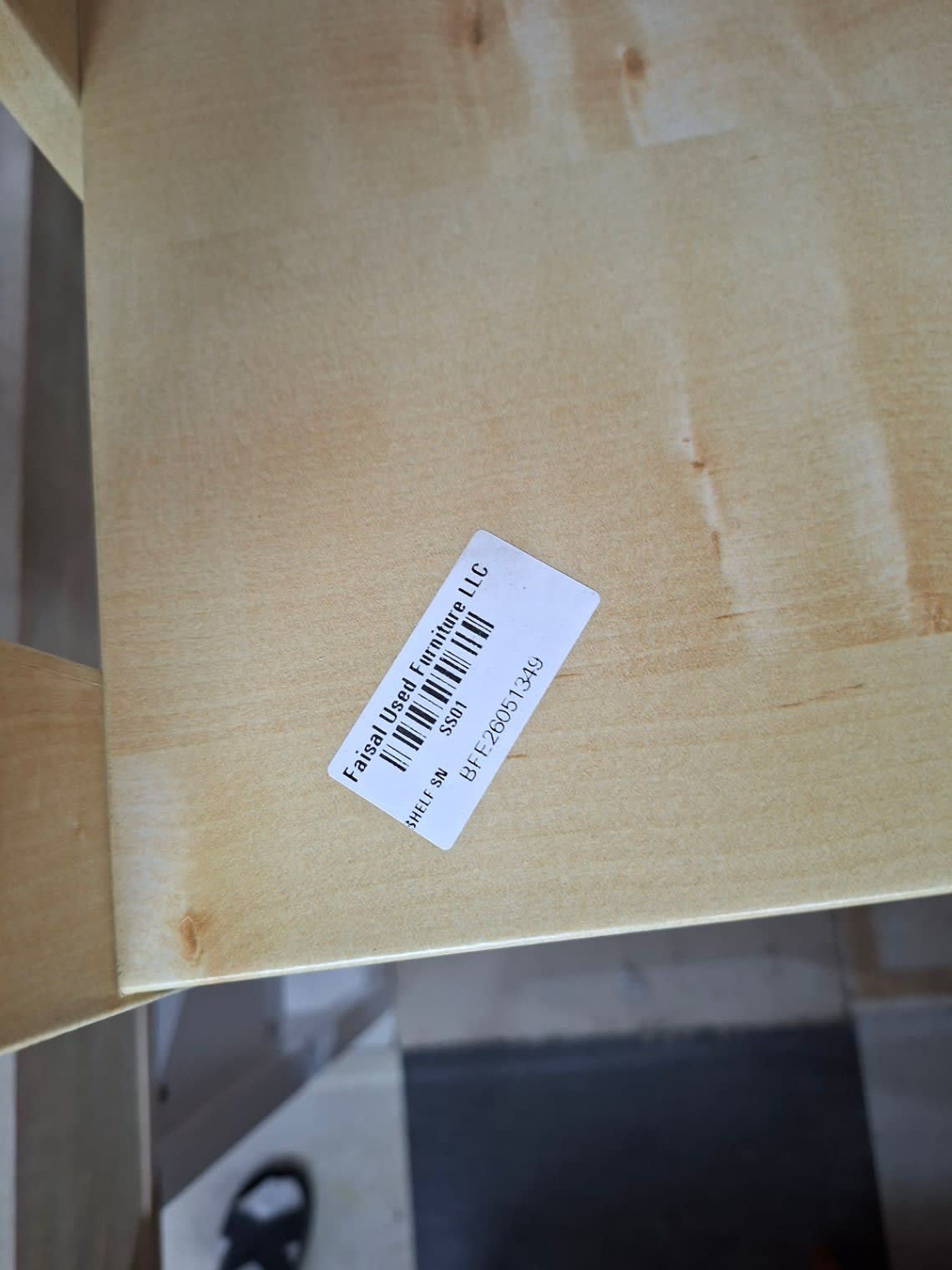 Bufaisal barcode label BFE26051349 on used 5-tier wooden bookshelf at Shop E Ajman