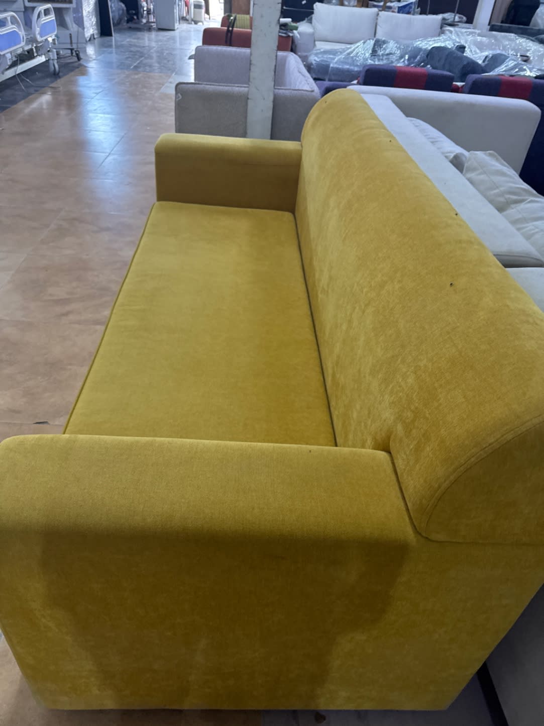 Opposite side view of used mustard yellow 3-seater sofa good condition at Bufaisal Ajman