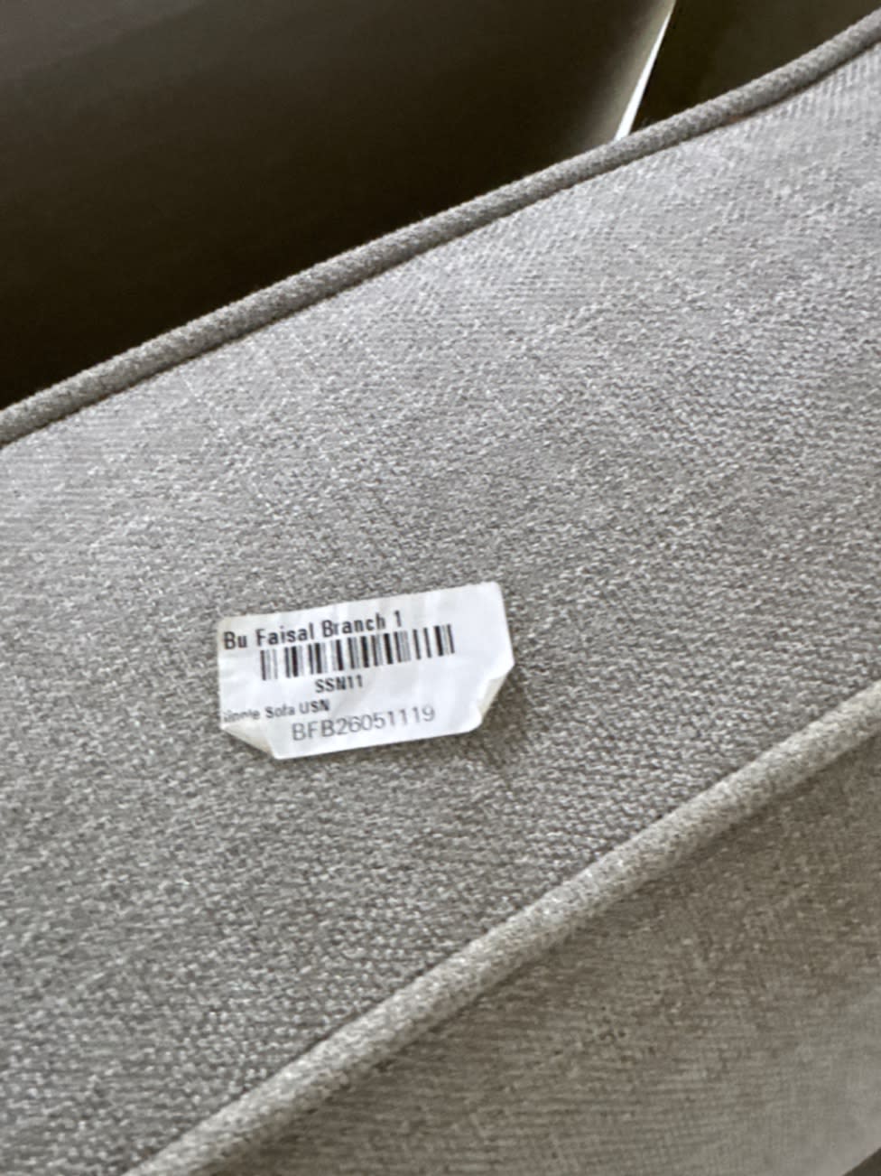 Bufaisal barcode label BFB26051119 on used 2-seater light grey fabric sofa