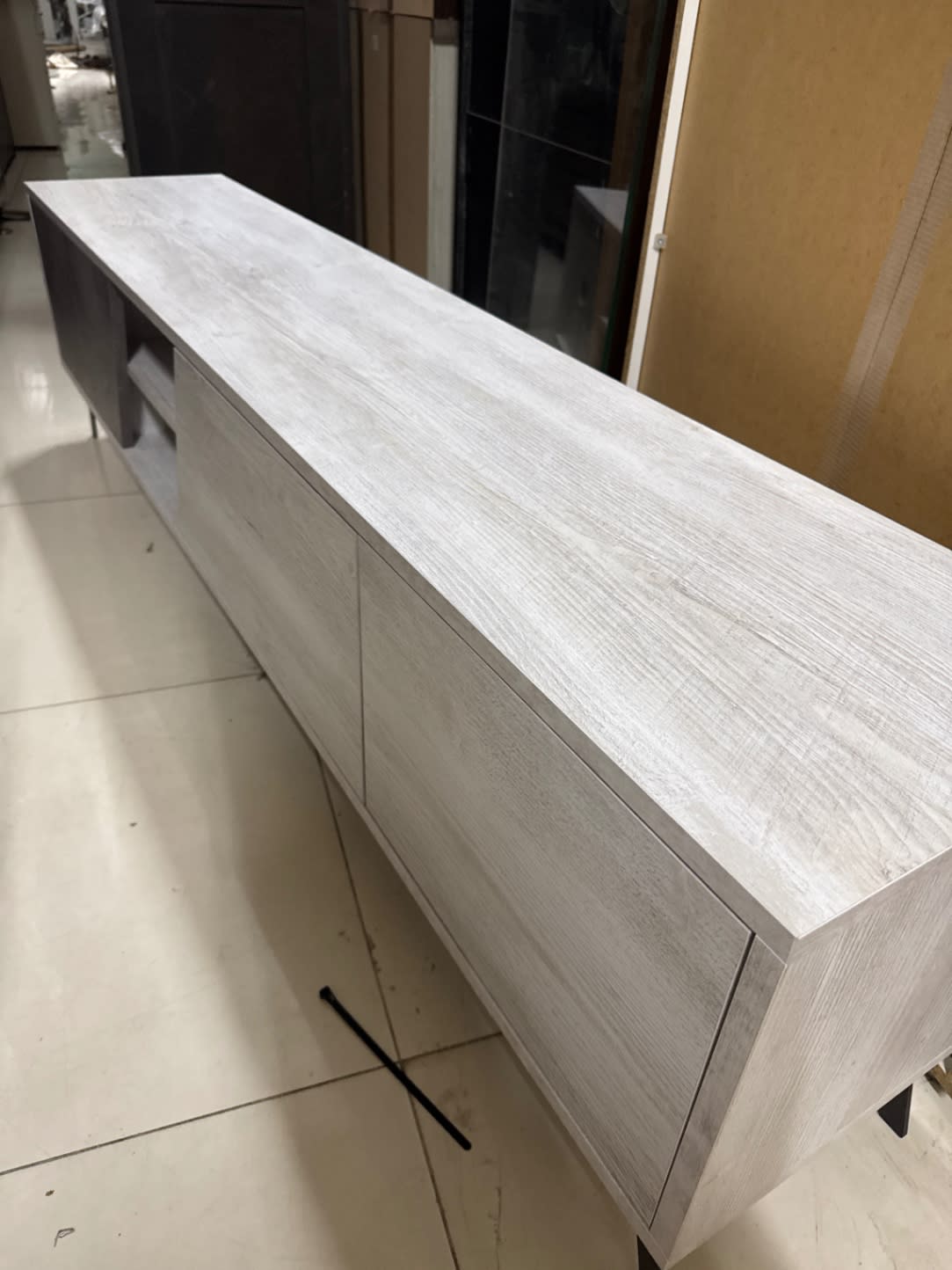 Second front-angle view of used TV unit with three drawers and open shelf at Bufaisal Ajman