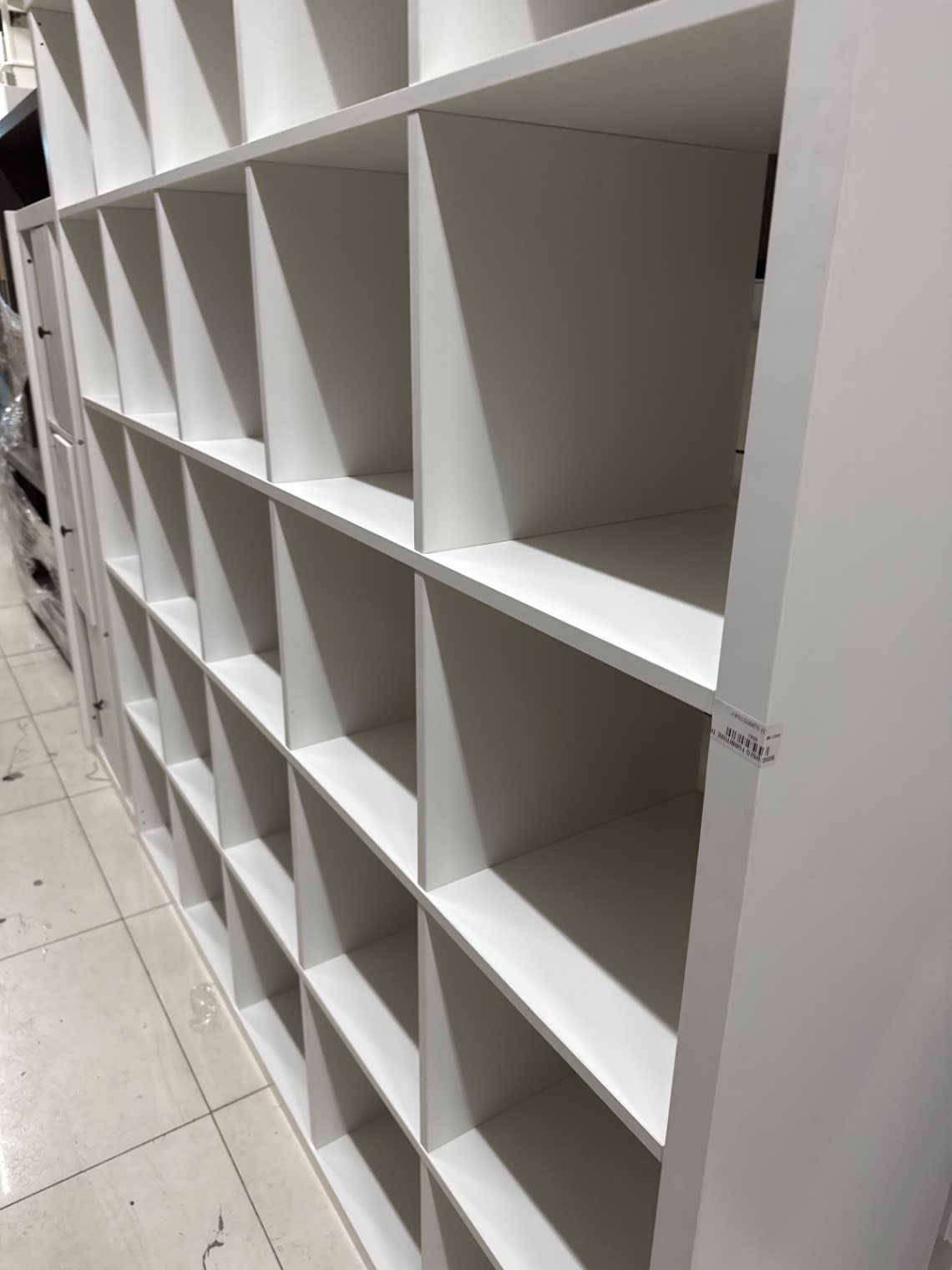 Bufaisal barcode label on used white open cube bookshelf at Shop C Ajman