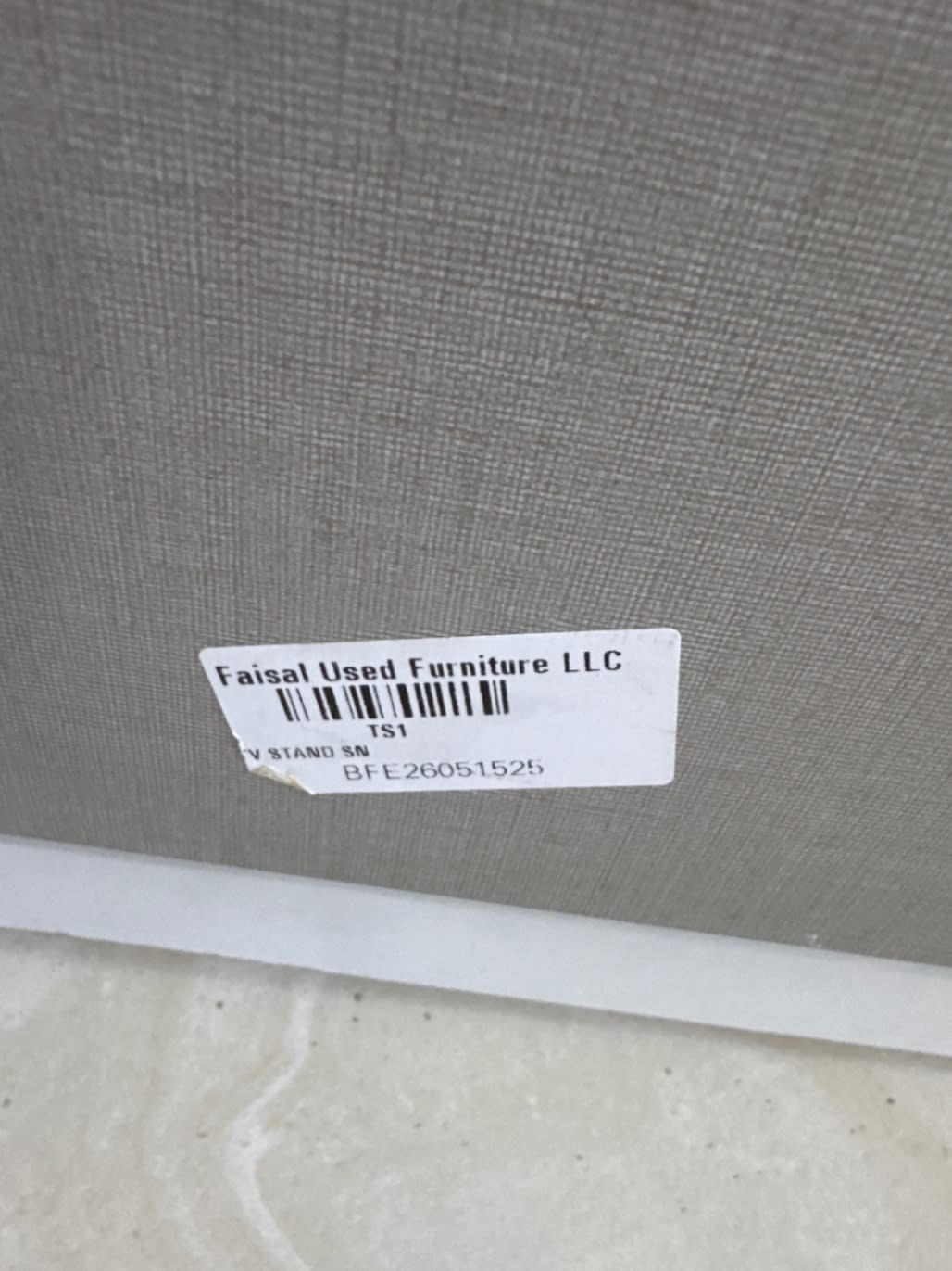 Bufaisal barcode label BFE26051525 for used TV stand at Shop E Ajman