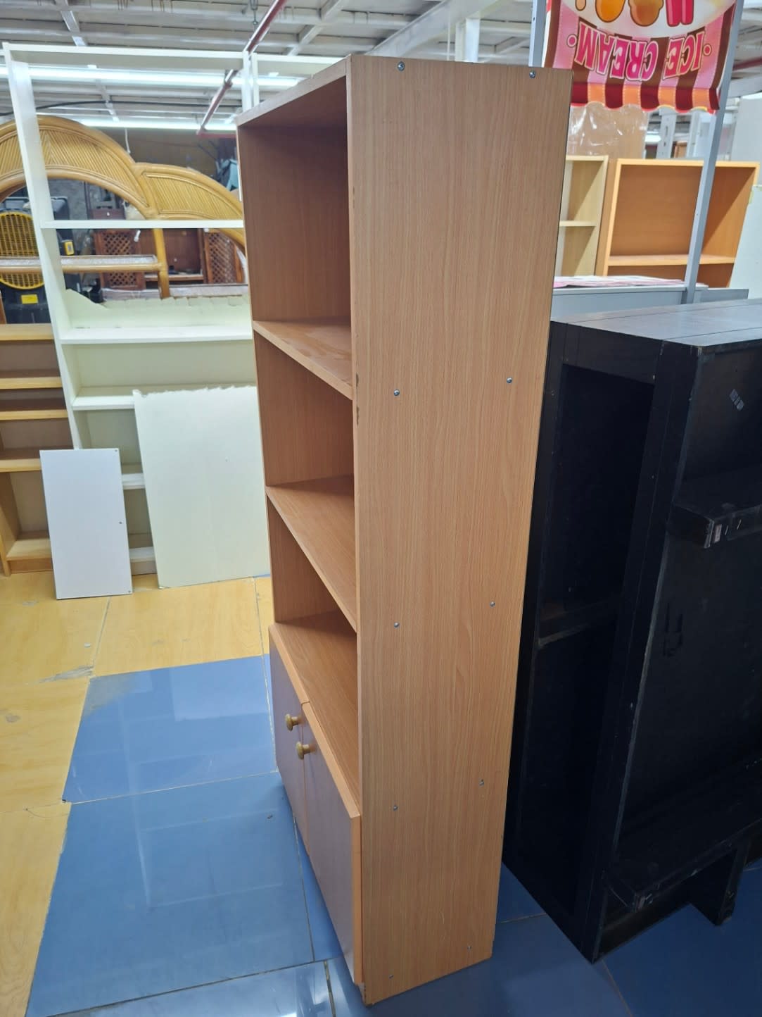 Side angle view of used light oak bookshelf with bottom cabinet at Bufaisal Shop D Ajman