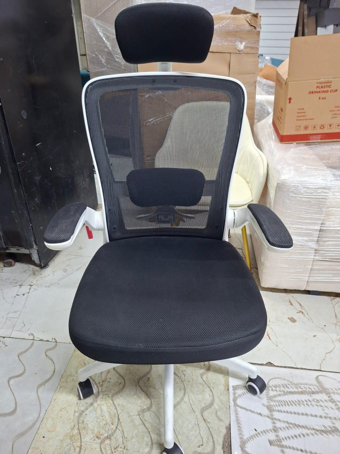 Front view of used high-back mesh office chair showing seat and armrests at Bufaisal Ajman