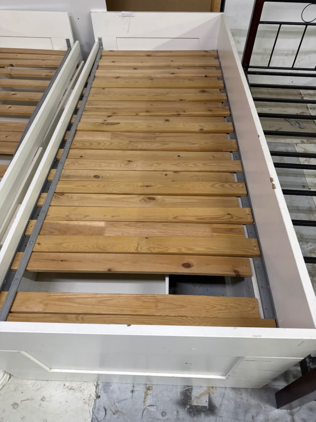 Fourth view of used white single day bed frame showing footboard and slat detail at Bufaisal Ajman