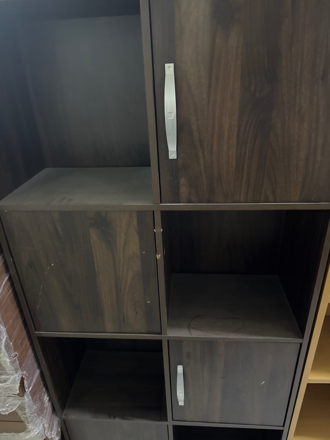 Close-up of door panels and silver handles on used 8-cube dark walnut storage cabinet Bufaisal Ajman