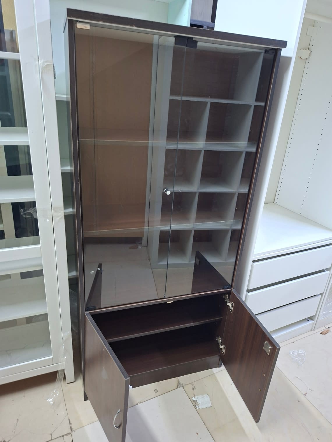 Used dark walnut office cabinet with lower doors open showing internal shelf and hinges at Bufaisal Shop C Ajman