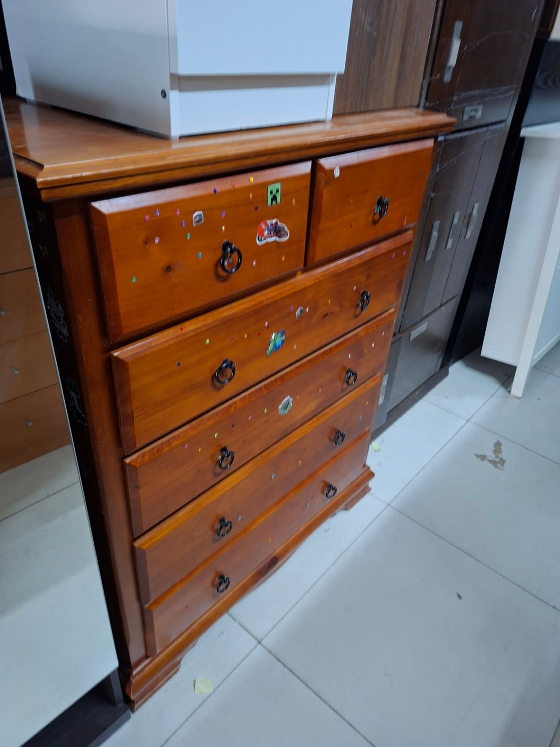 Side angle view of used honey brown 6-drawer chest of drawers at Bufaisal Shop C Ajman