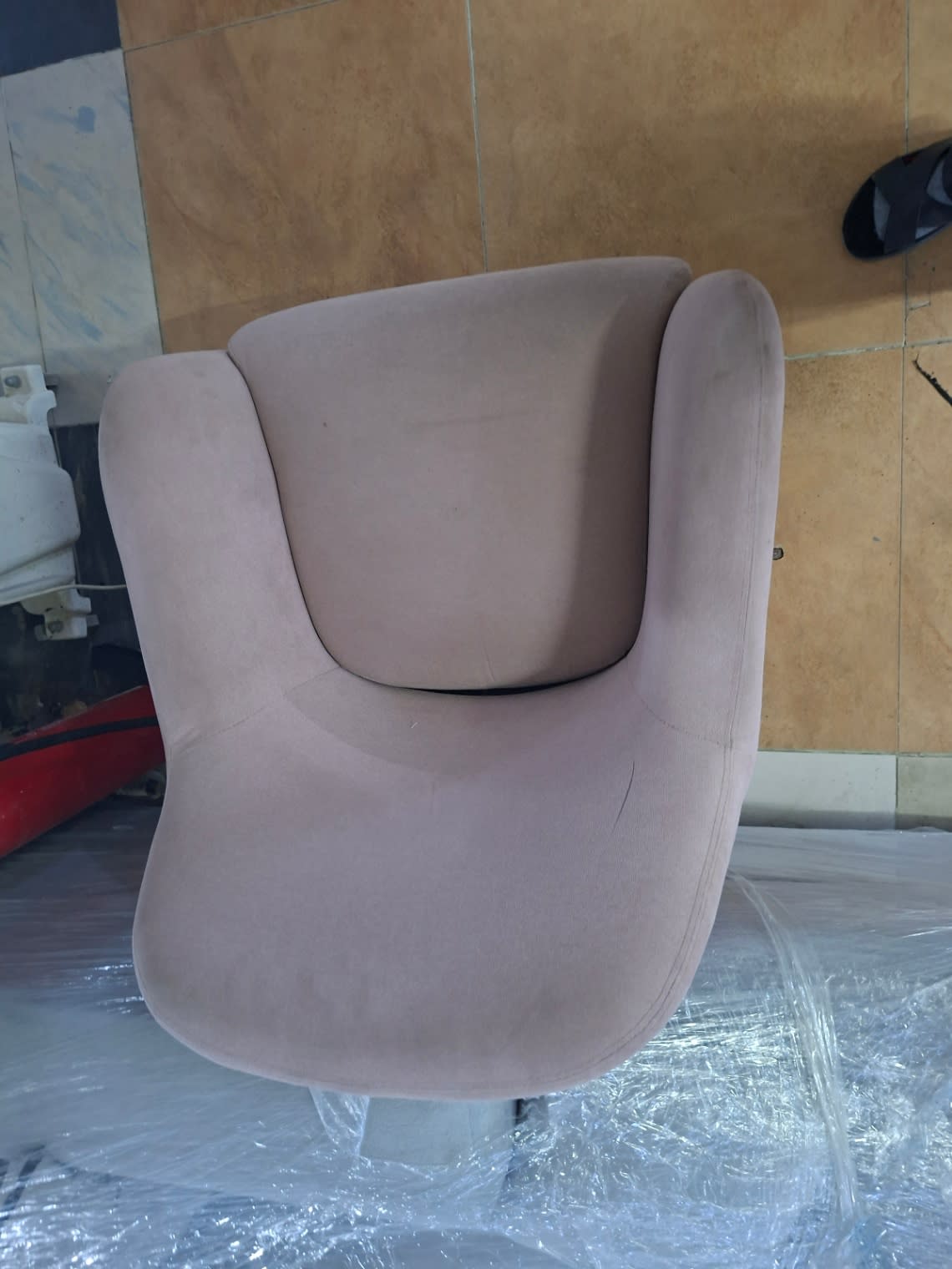 Rear view of used dusty pink fabric accent armchair showing back panel and metal legs Bufaisal