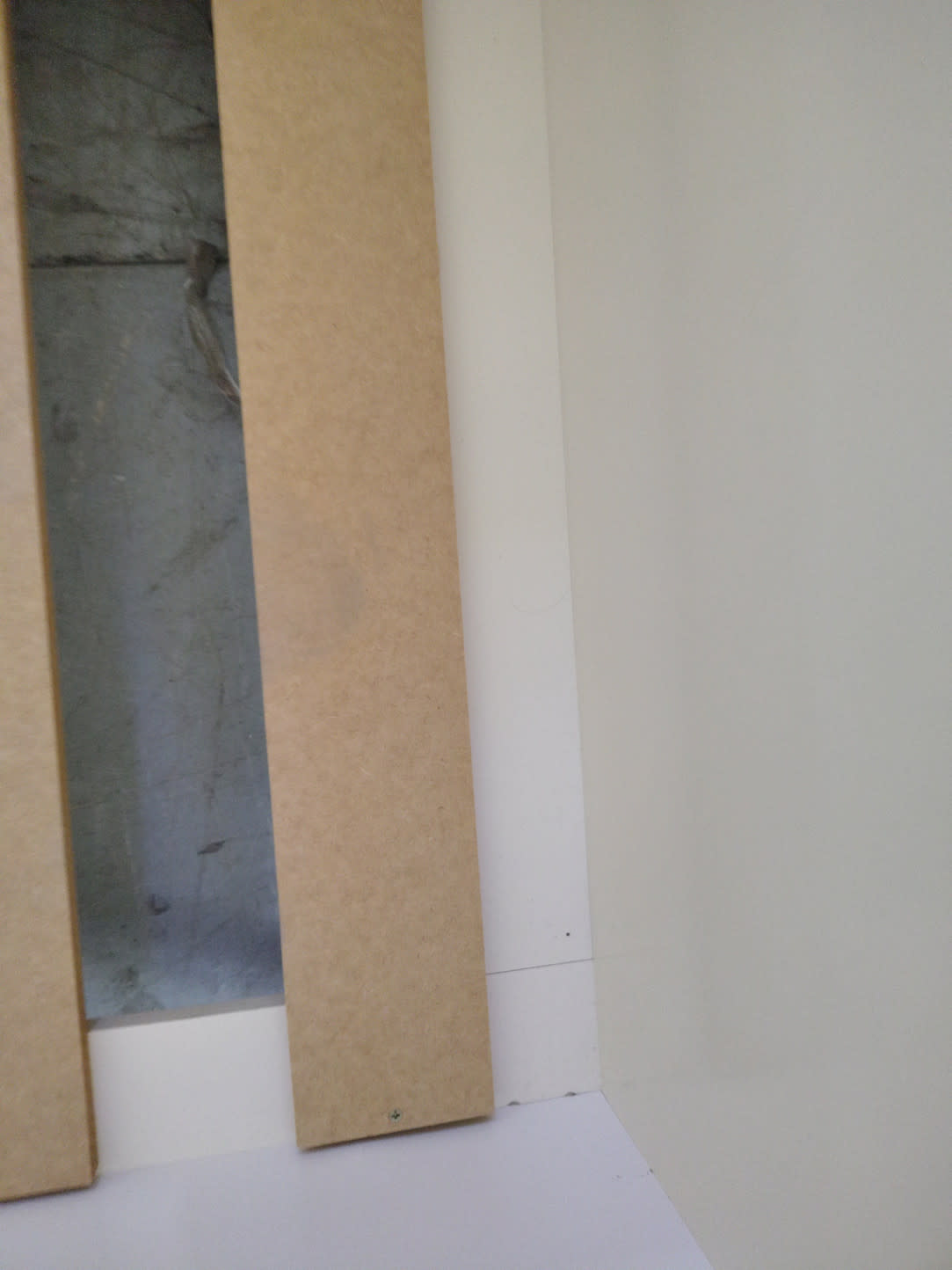Close-up of MDF slat and white panel edge of used kids single bed frame at Bufaisal