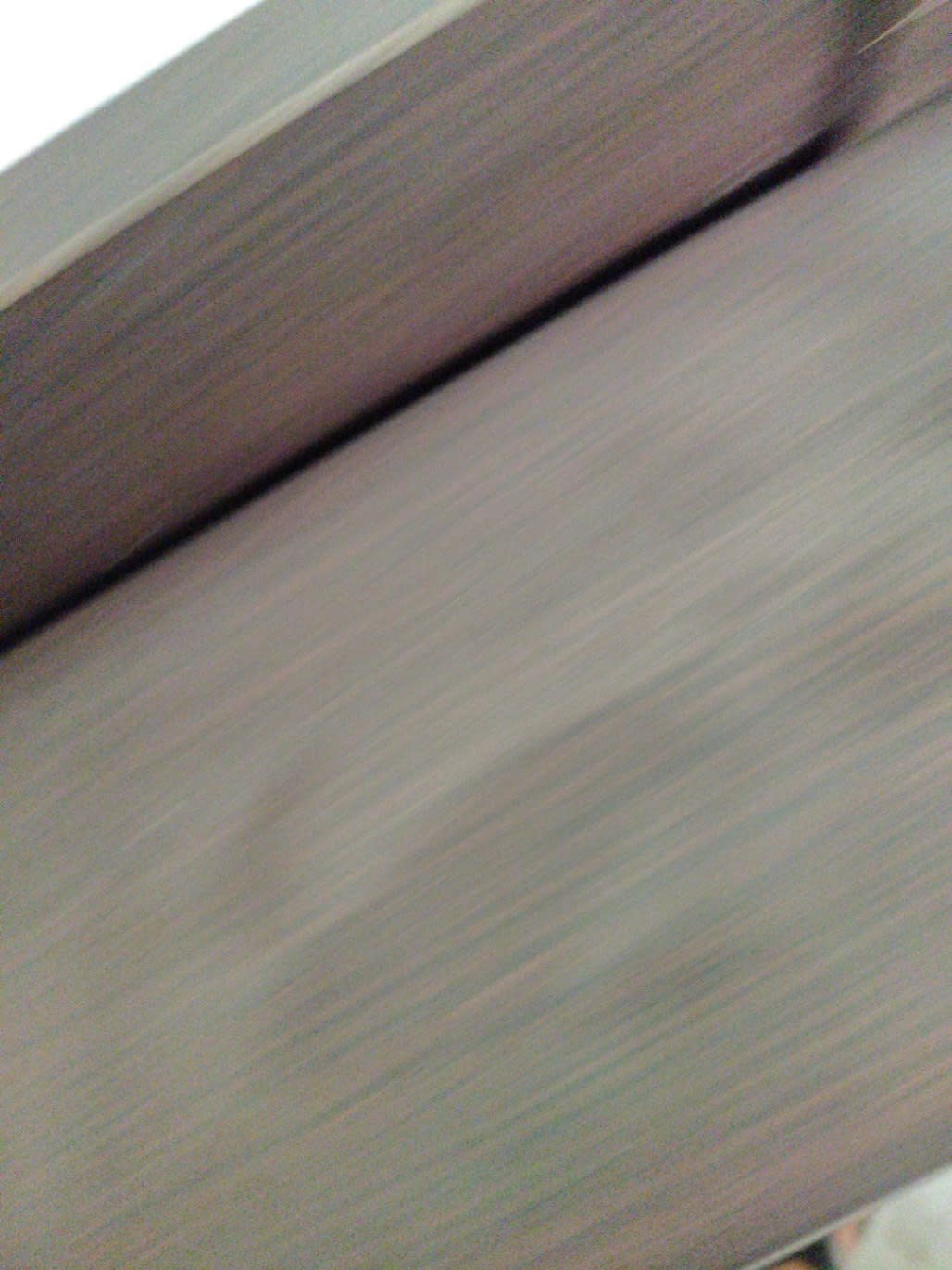 Close-up of dark brown wenge wood finish on used king bed frame at Bufaisal Ajman