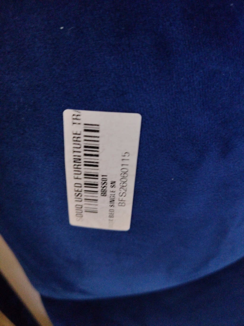 Bufaisal barcode label BFS26060115 for used single bed frame at Shop C Ajman