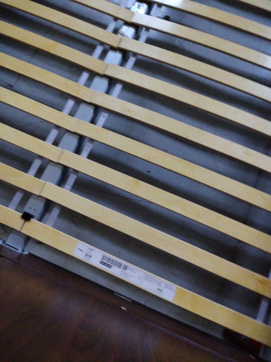 Manufacturer label visible on slat rail of used king bed frame at Bufaisal Ajman