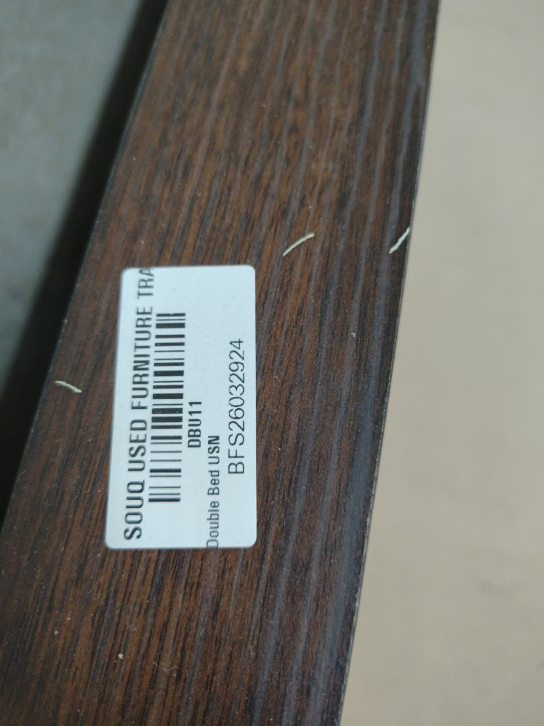 Bufaisal barcode label BFS26032924 for used double bed frame at Shop C Ajman