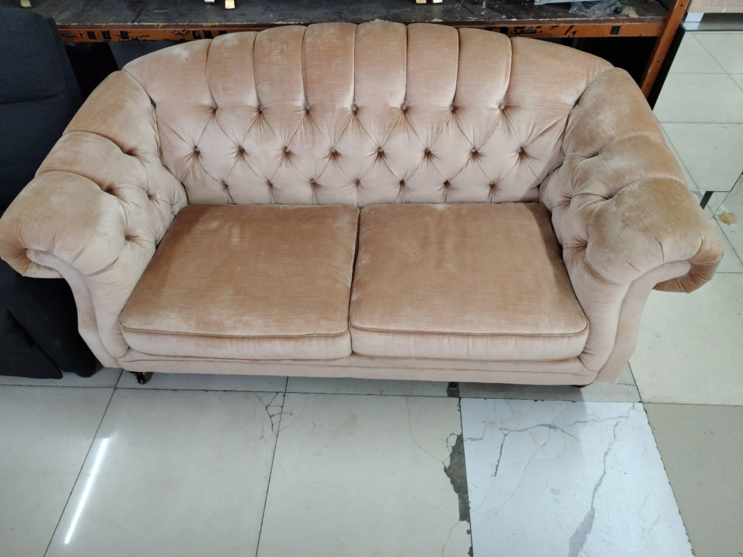 Front-on view of used Chesterfield 2-seater sofa showing seat cushion wear condition