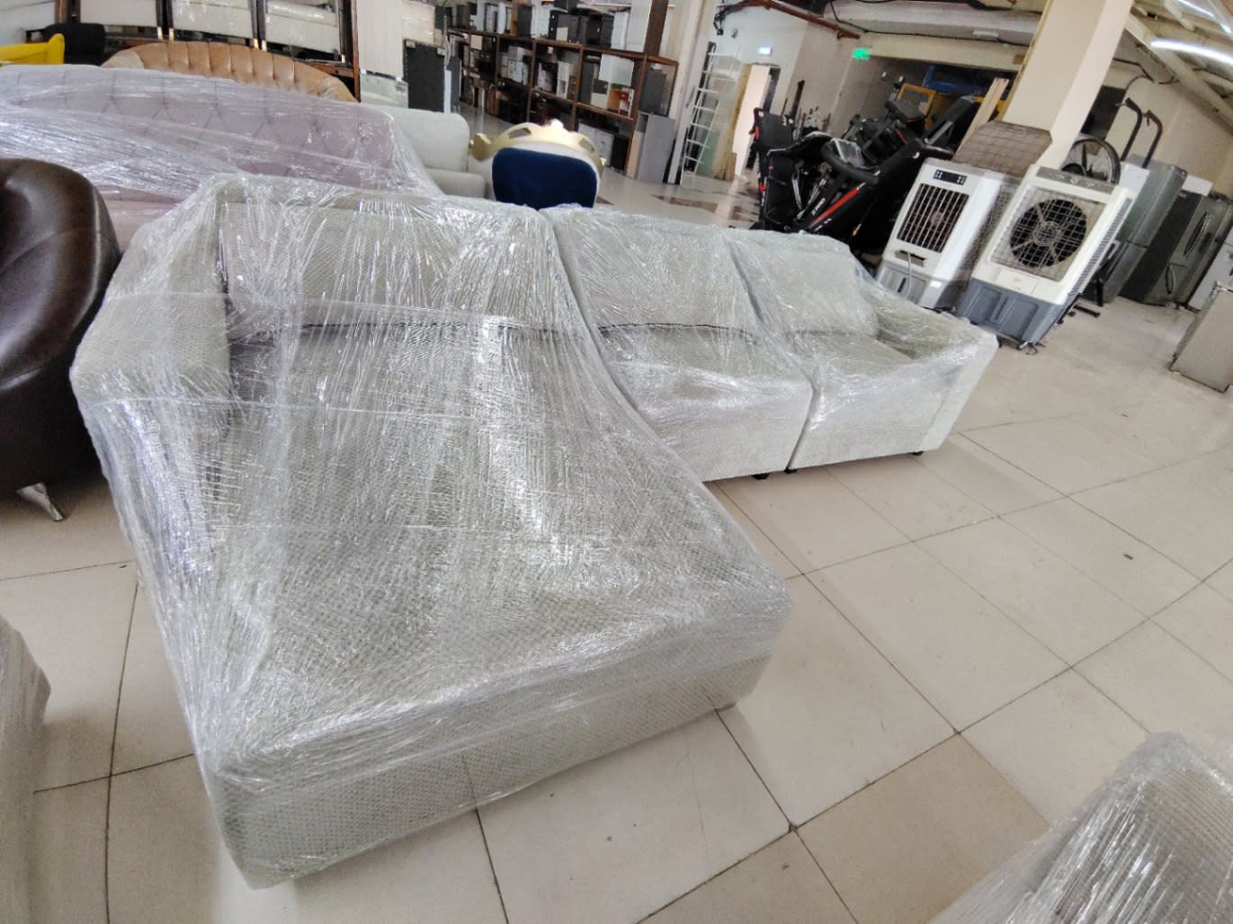 Full overhead angle of new L-shape sectional sofa light grey at Bufaisal Shop C Ajman showroom
