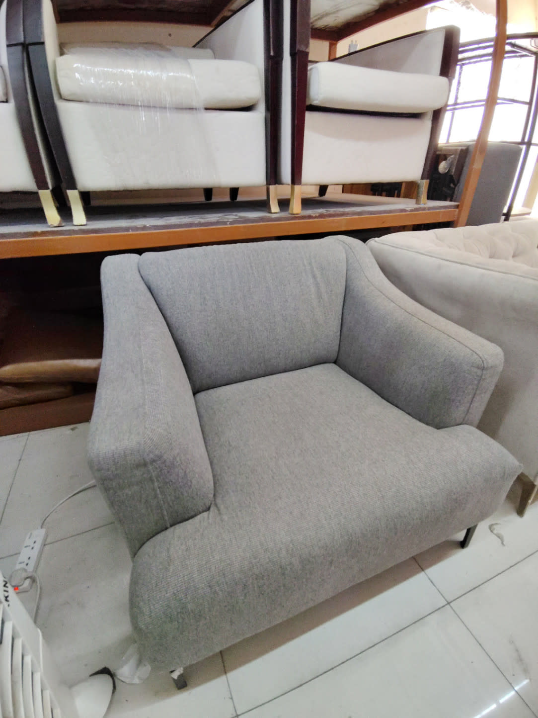 Bufaisal barcode label for used oversized grey armchair at Shop C Ajman
