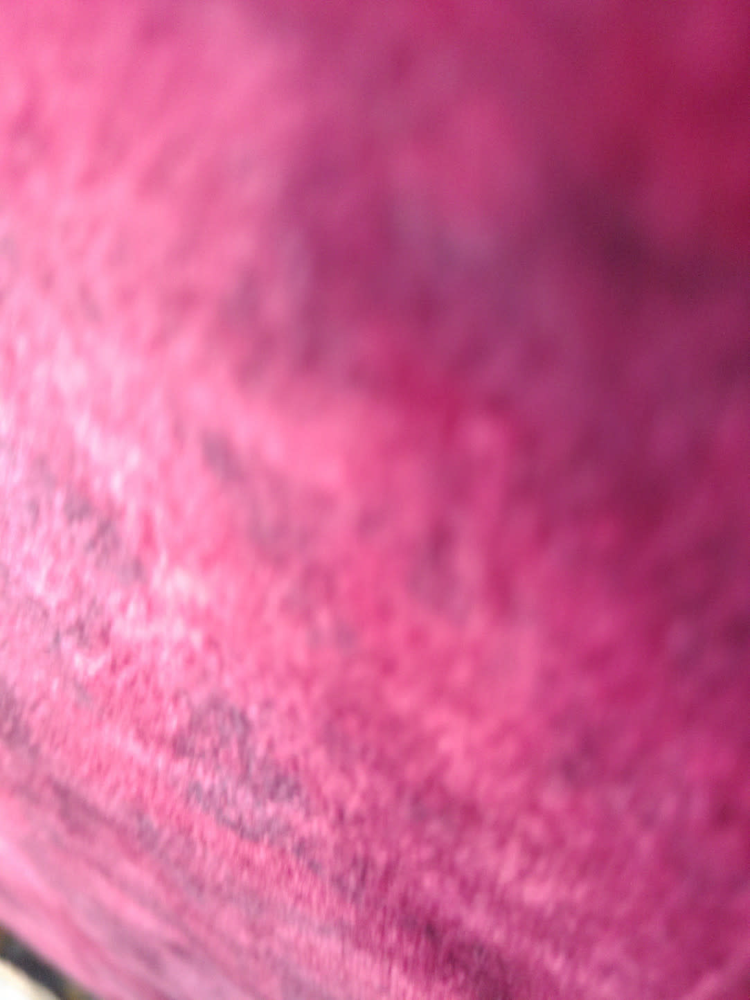 Barcode label photo unreadable — blurred pink surface, no barcode text visible