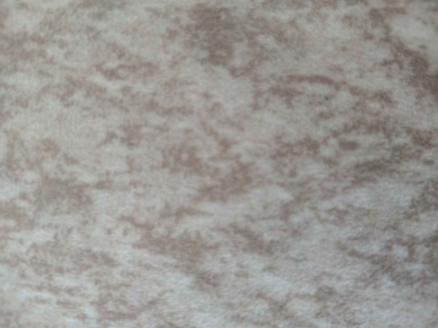 Close-up of beige textured fabric upholstery on new L-shape sectional sofa at Bufaisal Ajman