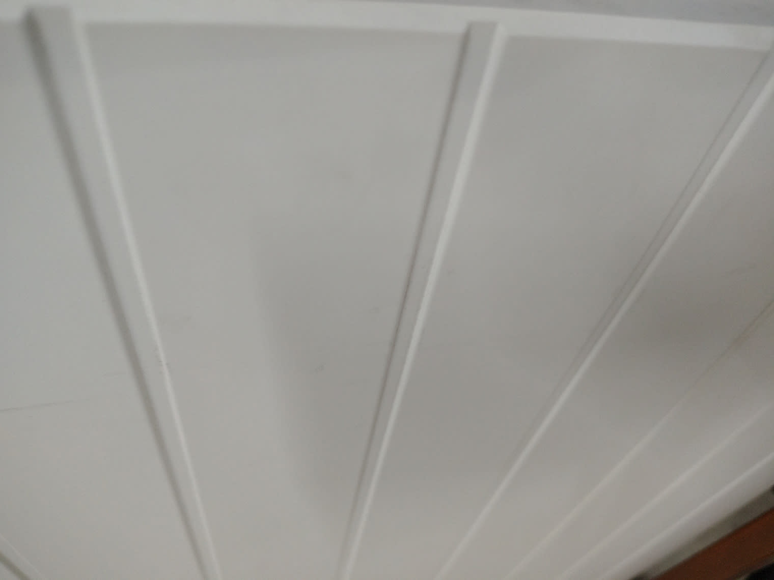 Close-up of groove-panel door face on used white storage cabinet showing minor surface scuffs