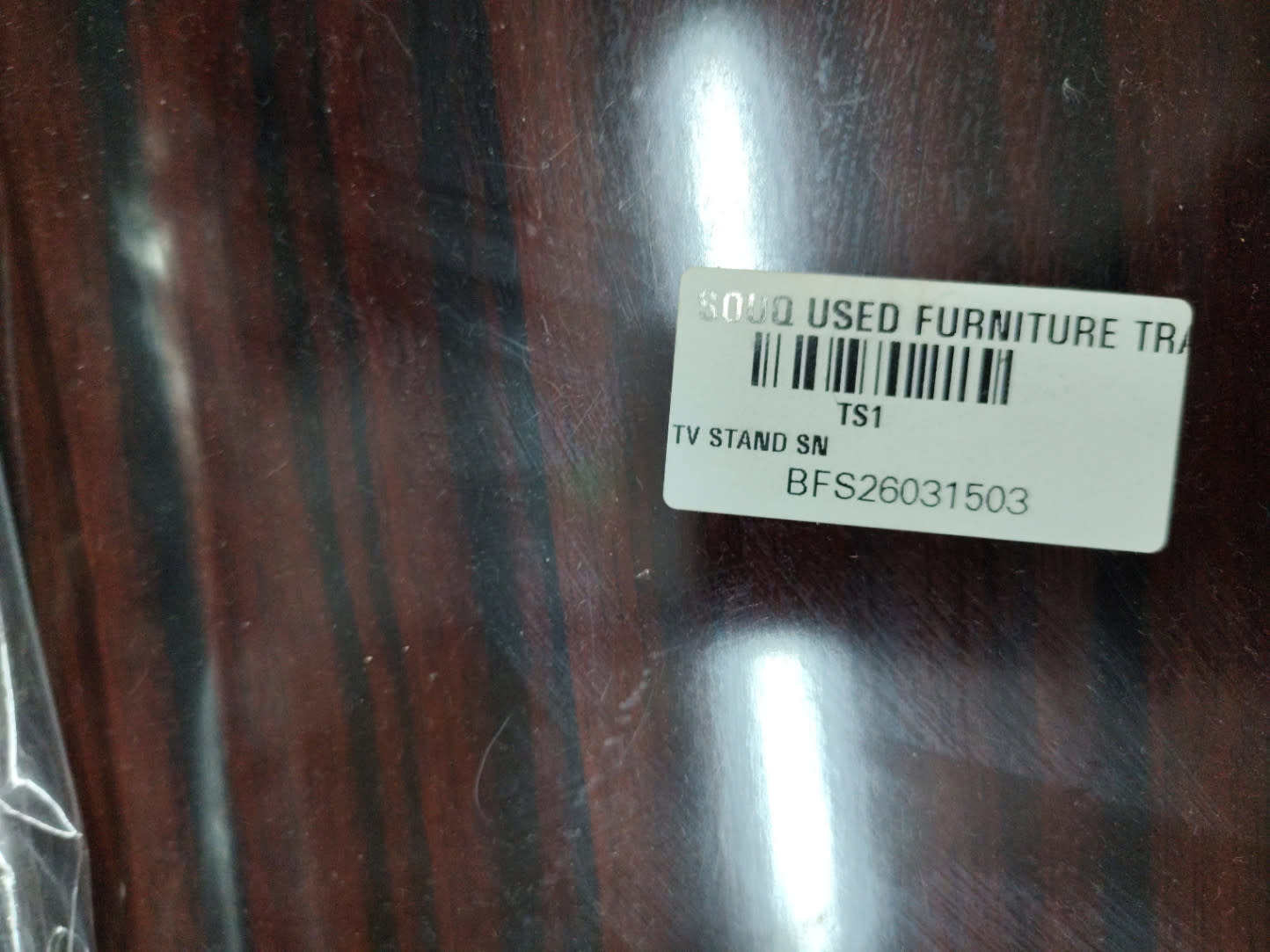 Bufaisal barcode label BFS26031503 for used TV stand at Shop C Ajman