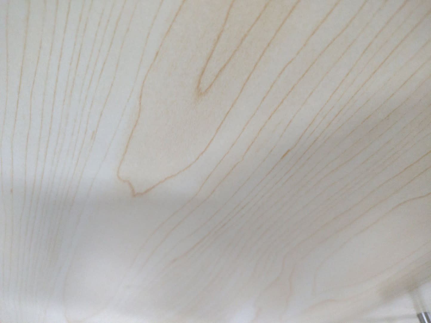 Close-up of cream wood-grain laminate surface of used low storage cabinet at Bufaisal
