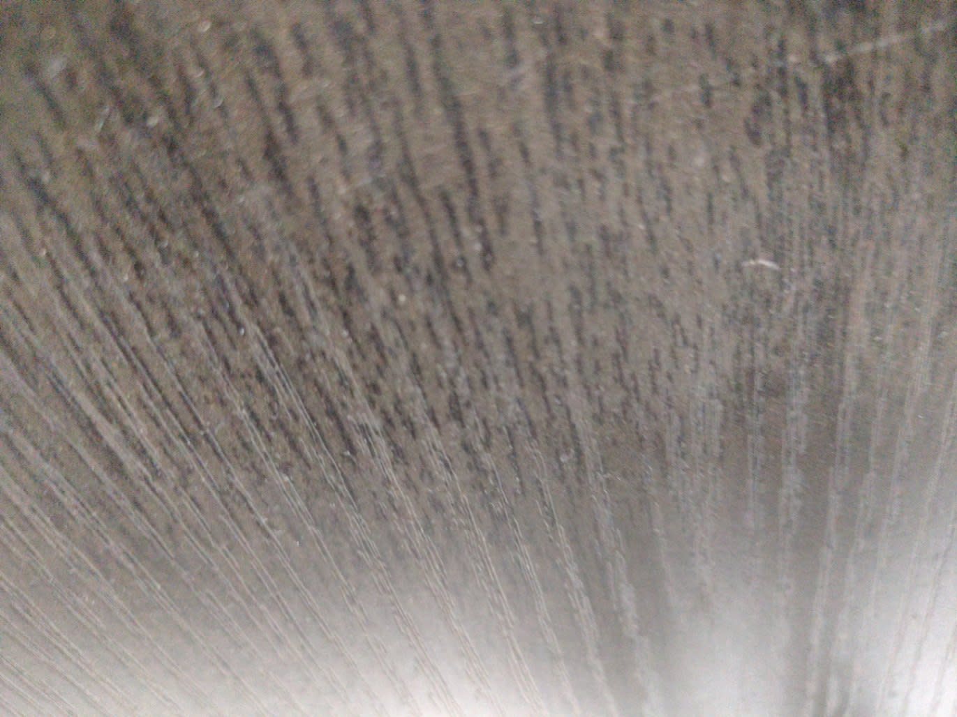 Close-up of surface scratches on top panel of used dark brown TV stand at Bufaisal Ajman