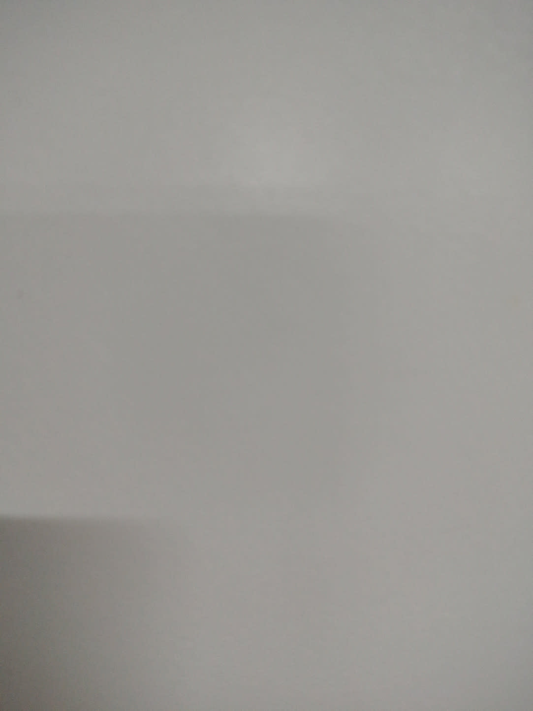 Barcode label photo for used white TV stand at Bufaisal — label unreadable