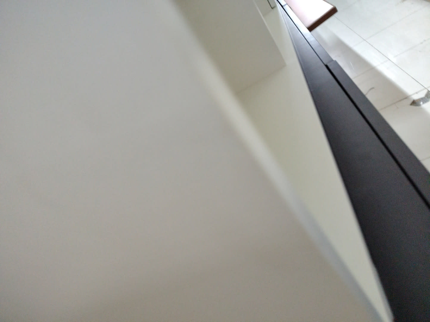 Close-up of white TV stand surface showing clean condition at Bufaisal Ajman