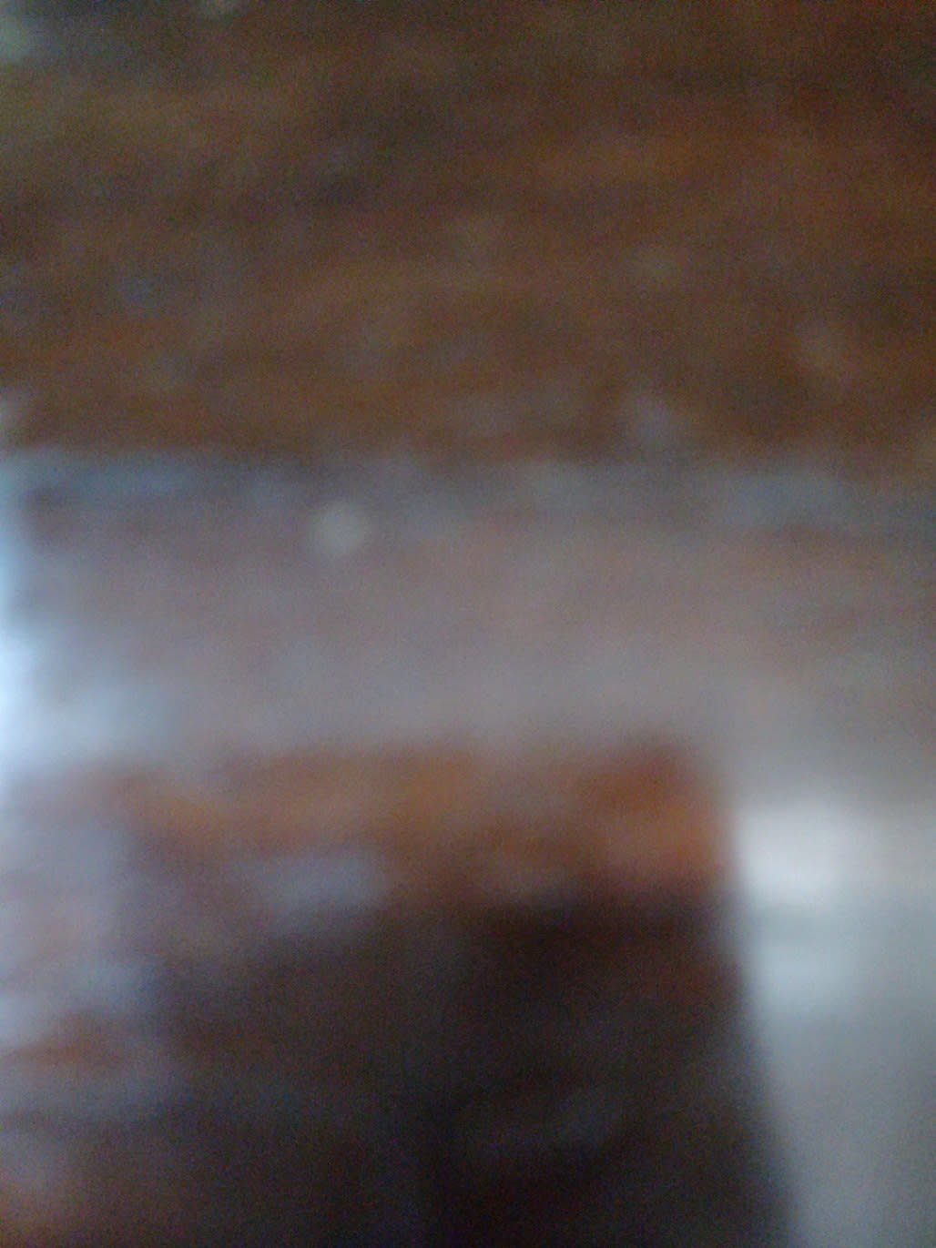 Barcode label photo for used wood TV stand at Bufaisal Ajman — label unreadable